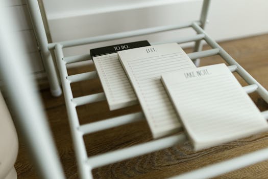 Close-up of elegant to-do, list, and note pads on a modern metal rack.